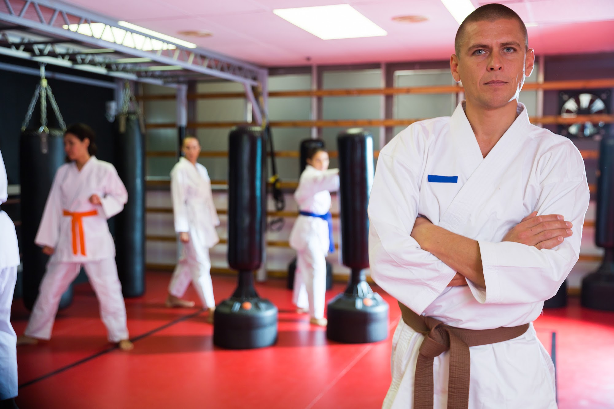 Modern BJJ gym with athletes and software dashboards in action