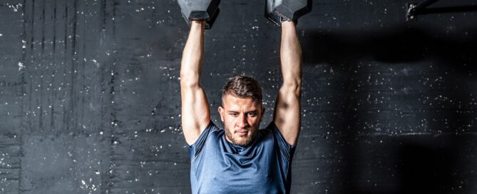 Gym owner reviewing software security protocols at a desk.
