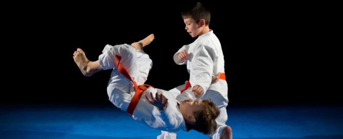 Martial arts students of varying ages training together, highlighting engagement and community supported by school management software.