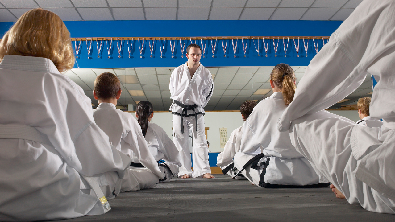 martial arts school owner reviewing student enrollment and operations during early business stage
