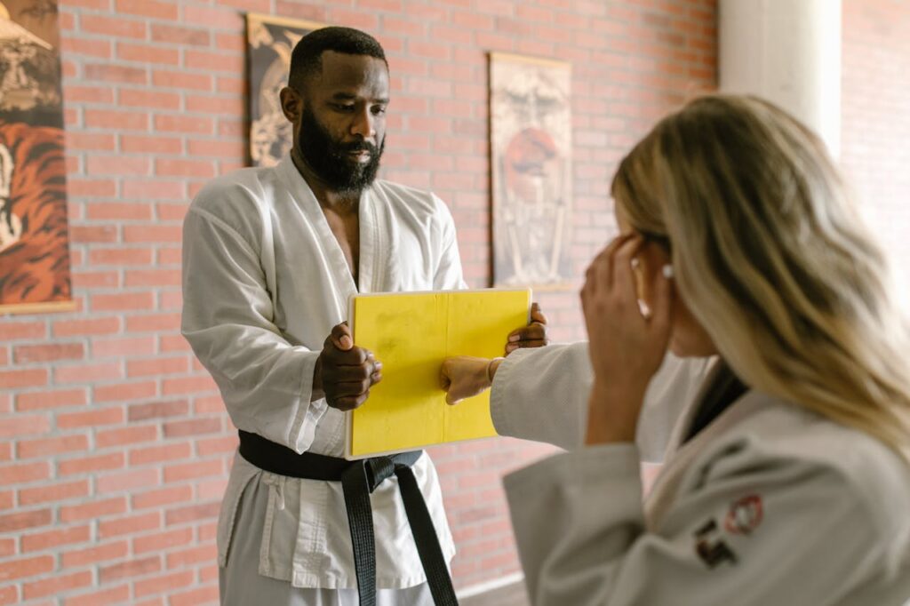 coach training a student in one-to-one coaching to improve client retention in martial arts studio