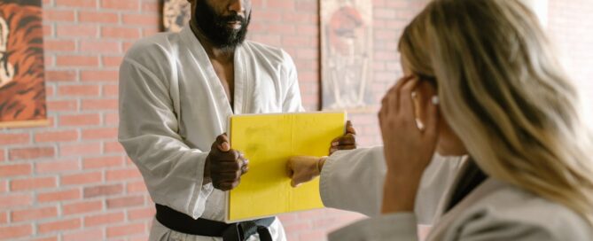 coach training a student in one-to-one coaching to improve client retention in martial arts studio