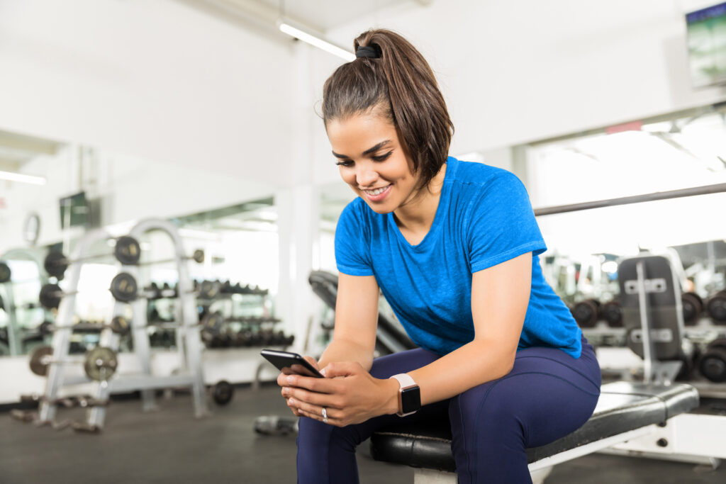 Gym owner using automation software to manage operations and member engagement