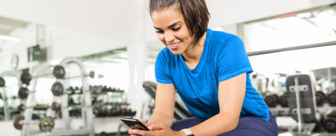 Gym owner using automation software to manage operations and member engagement