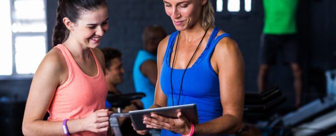 Gym owner reviewing automated payment and billing system on a laptop
