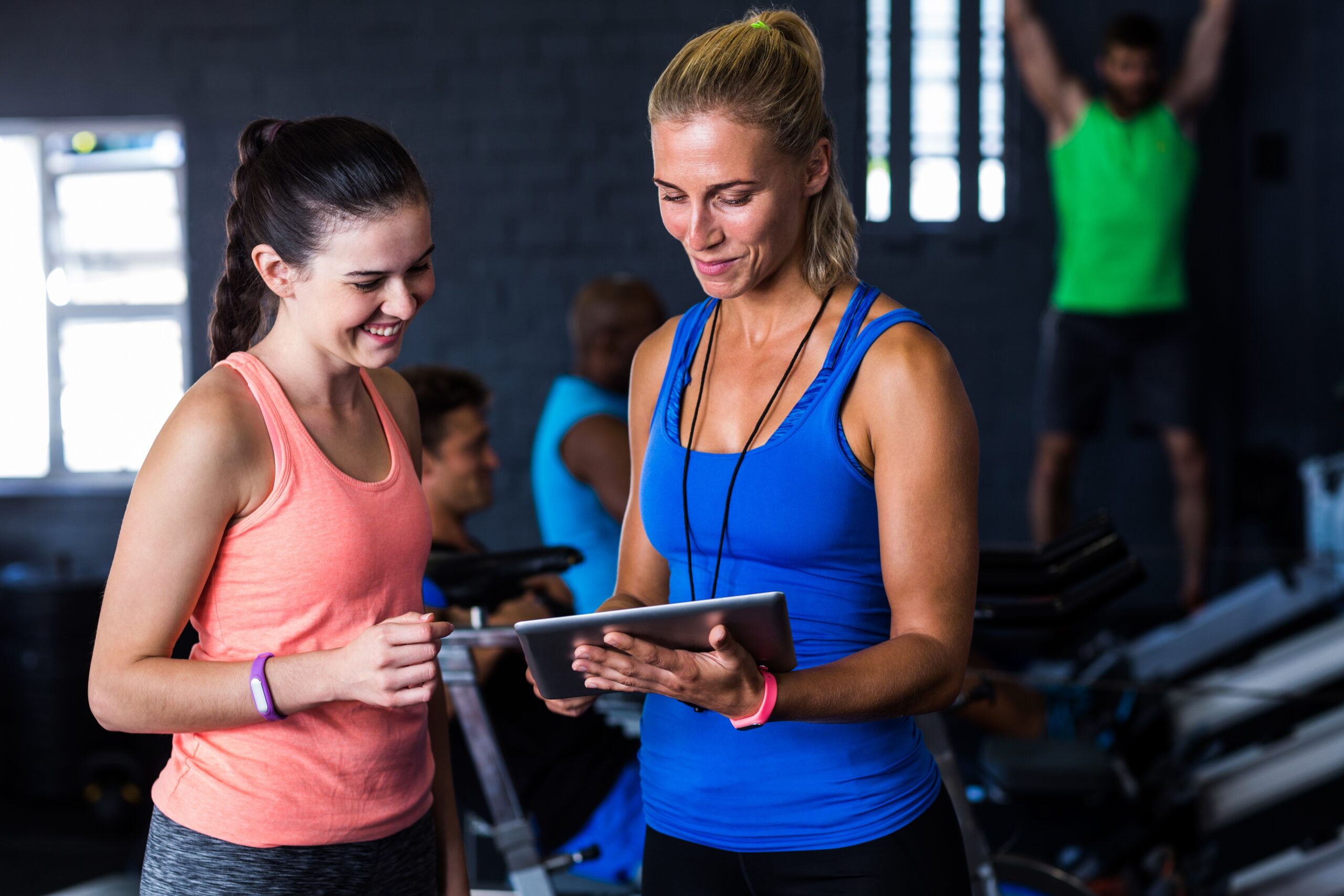 Gym owner reviewing automated payment and billing system on a laptop