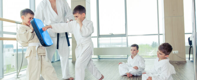 Martial arts instructor welcoming a new student during onboarding
